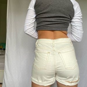 Cream Target jean shorts with orange/red stitching